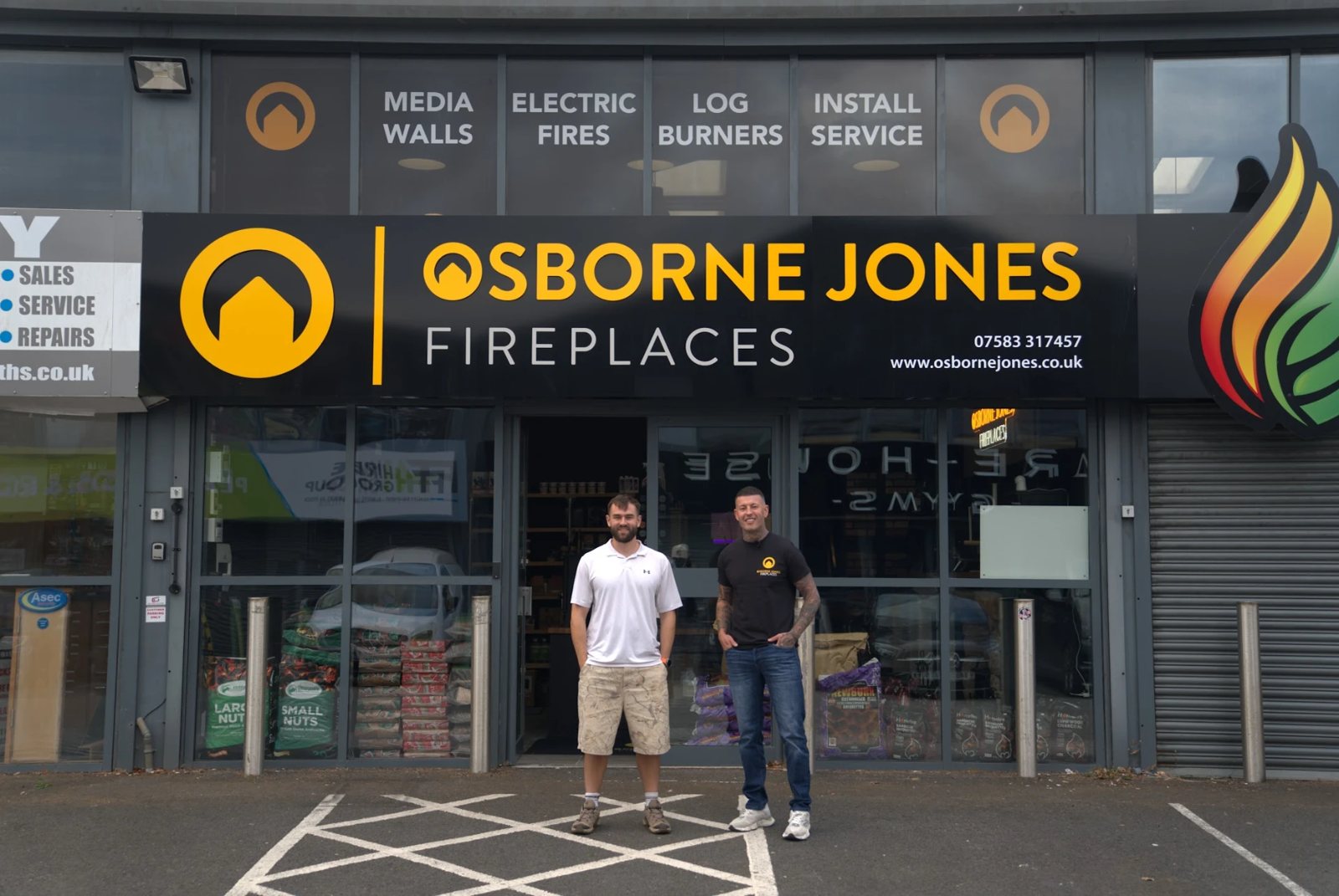 The Osborne Jones Fireplaces showroom in South Wales, with two of the team outside
